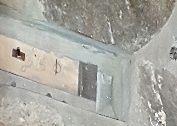 Close Photo of an embedded nailer to attach a mantle to a stone fireplace