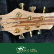 Photo of headstock of a wooden guitar with Goosebay Lumber branding on image
