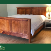 Photo of bed with table and lamp. Photo is branded to Goosebay Lumber and Sawmill